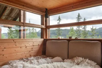 a room with two seats in a room with windows at Architectural Gem Near Cross Country Trails in Eggedal
