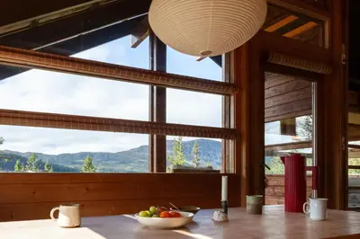 a table with a bowl of fruit in front of a window at Architectural Gem Near Cross Country Trails in Eggedal