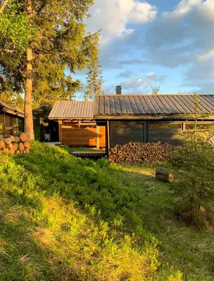 a house with a pile of logs in front of it at Architectural Gem Near Cross Country Trails in Eggedal