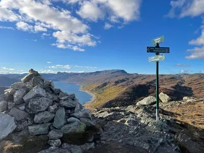 a sign on top of a mountain with a lake at Unique Hobbit Cabin By Hallingskarvet in Hovet