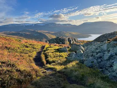 a view of a mountain with rocks and a lake at Unique Hobbit Cabin By Hallingskarvet in Hovet