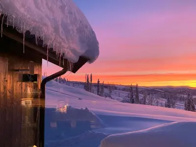 a view of a snow covered mountain at sunset at Cozy Ambiance And Trails At Skeikampen in Svingvoll