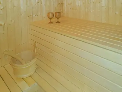 a wooden sauna with two wine glasses in it at Cozy Ambiance And Trails At Skeikampen in Svingvoll