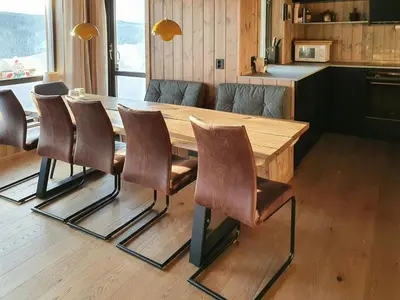 a dining room table with leather chairs around it at Cozy Ambiance And Trails At Skeikampen in Svingvoll