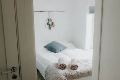 a bedroom with a bed with towels on it at Unique House On The Waterfront On Veiholmen in Smøla