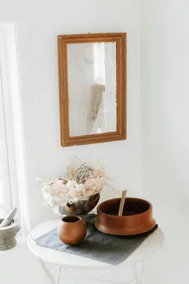 a table with a mirror and a bowl on it at Unique House On The Waterfront On Veiholmen in Smøla