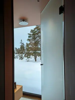 a door to a room with a view of a snow covered field at Modern Cabin By Snøhetta At Blefjell in Svene
