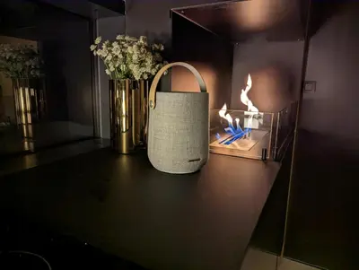 a purse sitting on a table next to a vase with flowers at Modern Cabin By Snøhetta At Blefjell in Svene