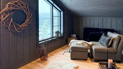 a living room with a chair and a window at Adventure And Relaxation In Voss in Vossevangen