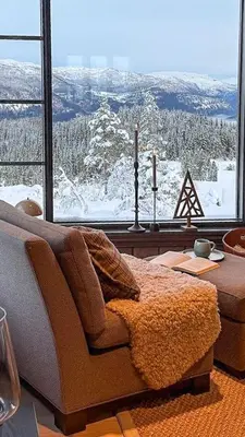 a living room with a couch and a large window at Adventure And Relaxation In Voss in Vossevangen
