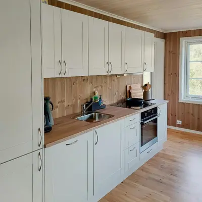 a kitchen with white cabinets and a sink at Unique Cabin By The Ski Slope In Hovden in Hovden