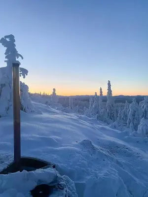 a snow covered hill with a pole in the snow at Log Cabin With Modern Style Near Vardefjell in Etnedal
