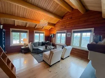 a living room filled with furniture and windows at Log Cabin With Modern Style Near Vardefjell in Etnedal