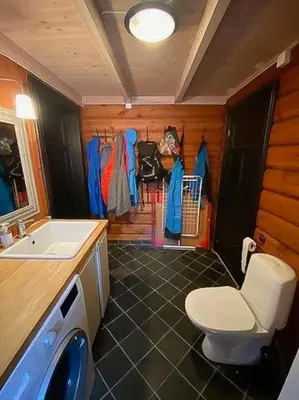a bathroom with a toilet and a sink in a room at Log Cabin With Modern Style Near Vardefjell in Etnedal