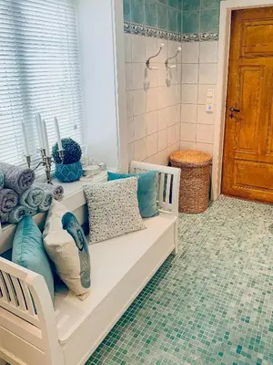 a white bench with pillows on it in a bathroom at Charming Southern Norway Idyll On Trøndelag Coast in Sula