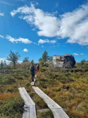 two people walking on a trail in a field at Mountain Cabin With Sauna At Blefjell in Lampeland