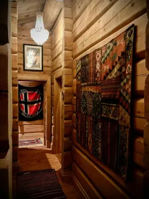 a hallway in a log cabin with a chandelier at Rustic Log Cabin At The Foot Of Hardangervidda in Uvdal