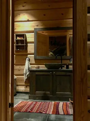 a kitchen with a sink and a mirror at Rustic Log Cabin At The Foot Of Hardangervidda in Uvdal