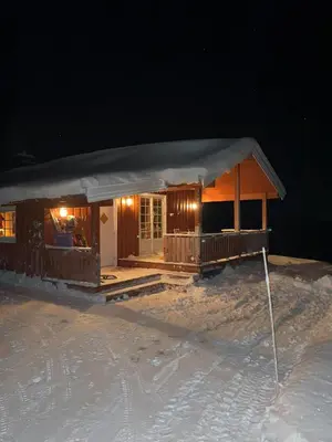 a small cabin in the snow at night at Charming Cabin With Fantastic View In Sjusjøen in Sjusjøen
