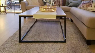 a living room with a coffee table and a couch at Seaside Dream Cabin With Jacuzzi in Steinsland