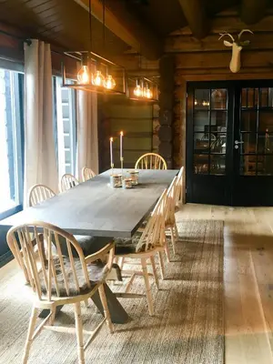 a dining room with a large wooden table and chairs at Timber Cabin With Fantastic View In Oppdal in Oppdal