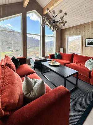 a living room with red couches and a table at Mountain Cabin Near Solheisen In Grøndalen in Hemsedal