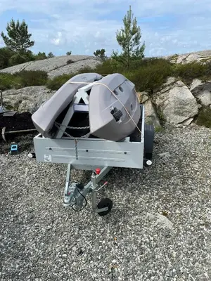 a boat sitting on a trailer on a rocky field at Cozy Family Cabin Surrounded By Idyllic Islands in Fitjar
