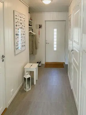 a room with a hallway with a door and a bench at Cozy Family Cabin Surrounded By Idyllic Islands in Fitjar