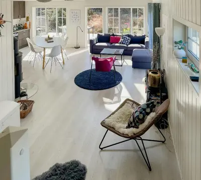 a living room with a couch and a table at Cozy Family Cabin Surrounded By Idyllic Islands in Fitjar