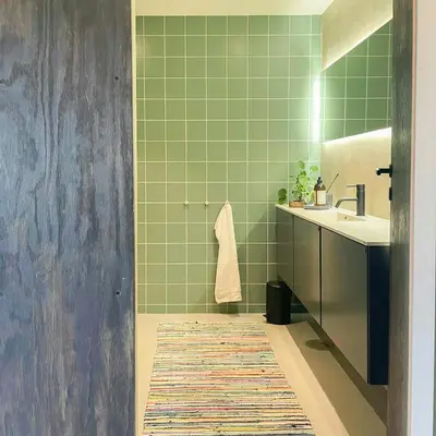 a green bathroom with a sink and a mirror at Seaside Boathouse In Veiholmen in Smøla