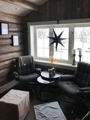a living room with two chairs and a star on the wall at Mountain Cabin With A View Over Jotunheimen in Tretten