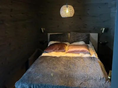 a bedroom with a bed with pillows and a lamp at Cabin With Panoramic And Ski Trails Outside in Rauland