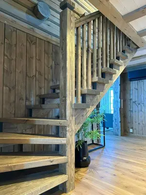 a wooden staircase in a room with wooden walls at Cabin With Panoramic View In Synnfjell in Nord Torpa