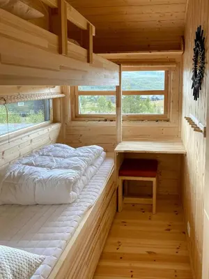 a small bedroom with a bed and a desk at Cabin With Award-Winning Design On Norefjell in Eggedal