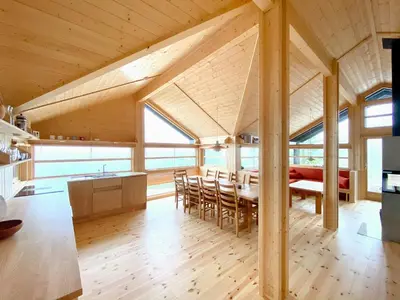 a kitchen and dining room with a wooden ceiling at Cabin With Award-Winning Design On Norefjell in Eggedal