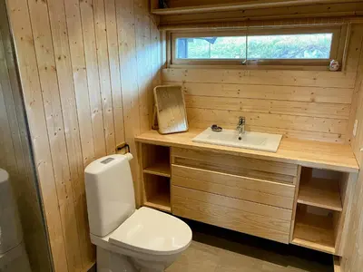 a small bathroom with a toilet and a sink at Cabin With Award-Winning Design On Norefjell in Eggedal
