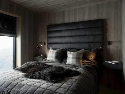 a bedroom with a large bed with a black headboard at Unique & Exclusive Mountain Cabin In Geilo in Geilo