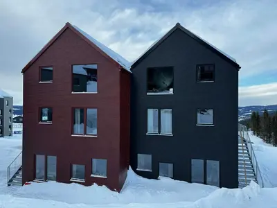 two houses in the snow in the snow at Modern Apartment Overlooking Gudbrandsdalen in Øyer