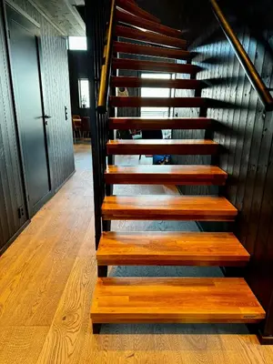 a set of wooden stairs in a building at Modern Apartment Overlooking Gudbrandsdalen in Øyer