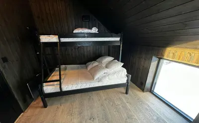 a bunk bed with white pillows in a room at Modern Apartment Overlooking Gudbrandsdalen in Øyer