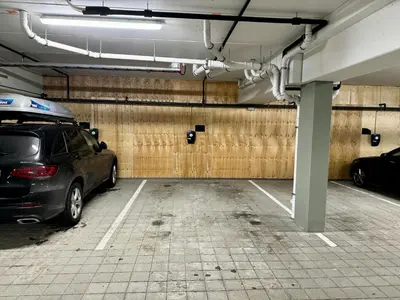 a parking garage with a car parked in it at Modern Apartment Overlooking Gudbrandsdalen in Øyer