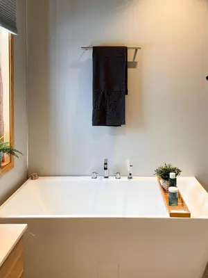 a large white bath tub in a bathroom at Architect Drawn Cabin Between Sea And Mountain in Hosen
