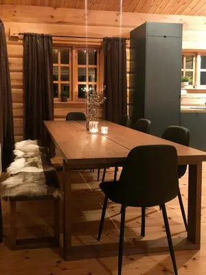 a wooden table and chairs in a room at Spacious Log Cabin Near Hardangervidda in Uvdal