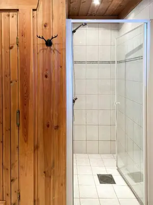 a bathroom with a shower and a glass door at Spacious Log Cabin Near Hardangervidda in Uvdal