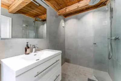 a bathroom with a white sink and a shower at Charming House In Loen, In The Heart Of Nordfjord in Loen