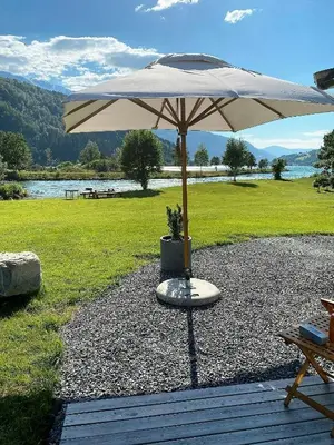 a large umbrella sitting on top of a field at Charming House In Loen, In The Heart Of Nordfjord in Loen