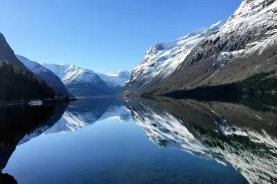 a reflection of a mountain in a body of water at Charming House In Loen, In The Heart Of Nordfjord in Loen