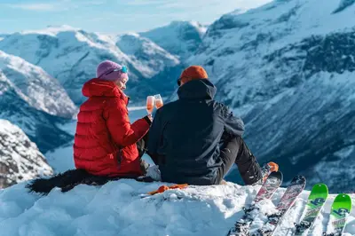 two people sitting on top of a snow covered mountain at Charming House In Loen, In The Heart Of Nordfjord in Loen