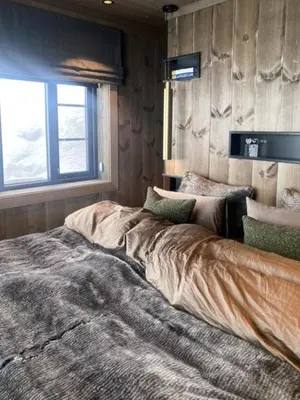 a bedroom with a large bed in front of a window at Mountain Home On Høgevarde With Majestic Views in Flå