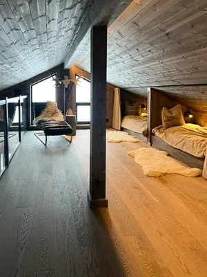 a room with two beds and a chair in it at Mountain Home On Høgevarde With Majestic Views in Flå